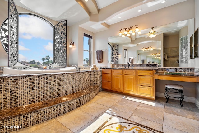 bathroom with vanity, ceiling fan, and tiled tub