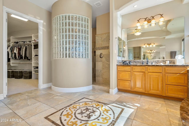 bathroom featuring a tile shower and vanity