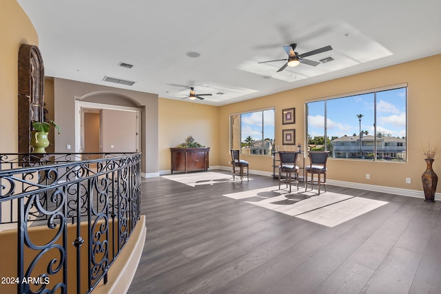 living area with hardwood / wood-style flooring, ceiling fan, and a healthy amount of sunlight