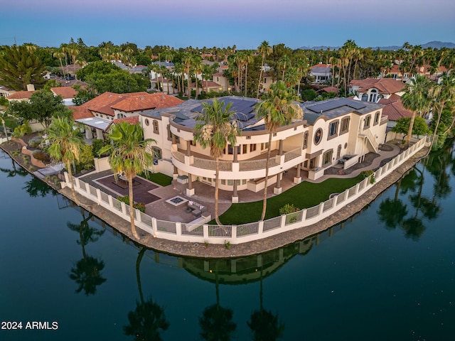 aerial view at dusk with a water view