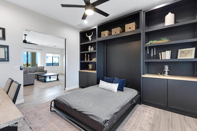 bedroom featuring light wood-type flooring and ceiling fan