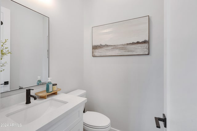 bathroom with toilet and vanity