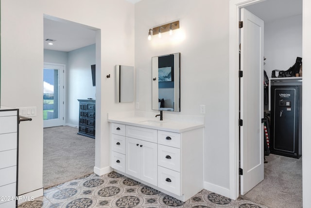 bathroom with visible vents, vanity, and baseboards