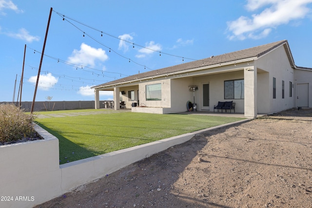 view of front facade featuring a front yard, fence, and stucco siding