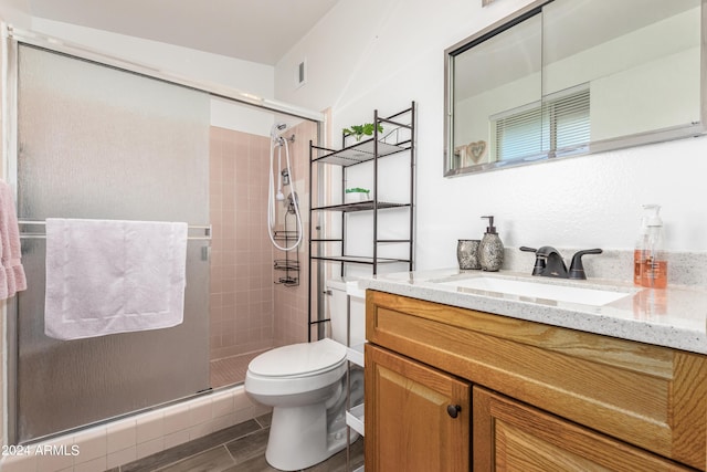 bathroom featuring walk in shower, vanity, and toilet