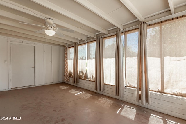 unfurnished sunroom featuring ceiling fan