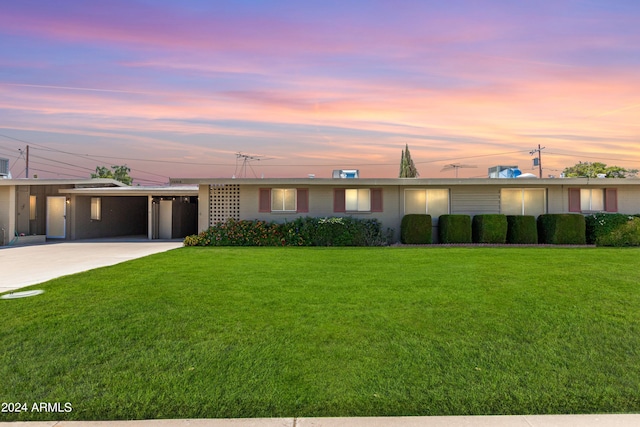 single story home with a carport and a yard