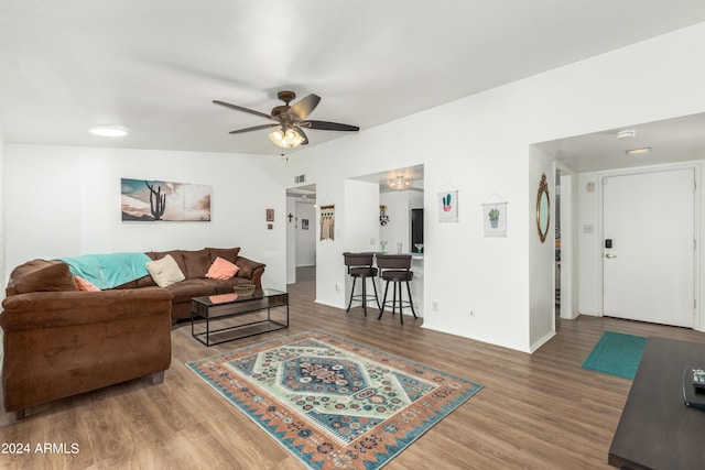 living room featuring hardwood / wood-style flooring and ceiling fan