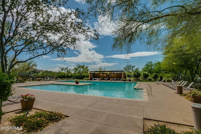 community pool featuring a patio area and a hot tub