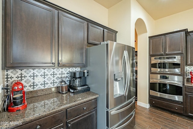 kitchen with stainless steel appliances and dark brown cabinetry