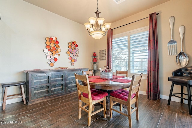 dining room featuring a chandelier, baseboards, and wood tiled floor