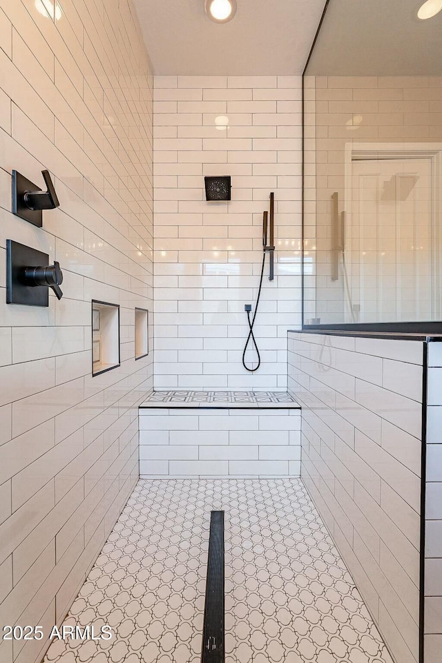 bathroom with recessed lighting and a tile shower