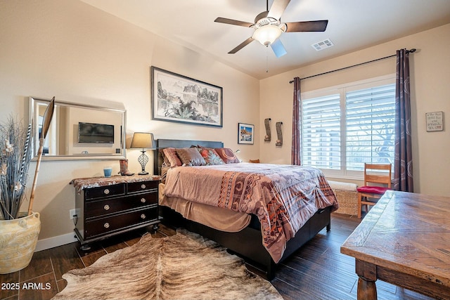 bedroom with dark wood-type flooring, visible vents, ceiling fan, and baseboards