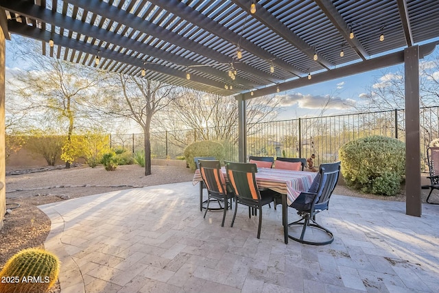 view of patio featuring outdoor dining space, a fenced backyard, and a pergola