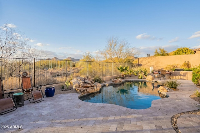 view of swimming pool with a patio, a fenced backyard, and a fenced in pool