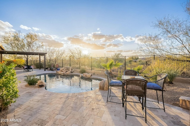 view of swimming pool featuring a patio, outdoor dining space, a fenced backyard, and a fenced in pool