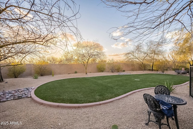 surrounding community featuring a yard, a patio area, and a fenced backyard