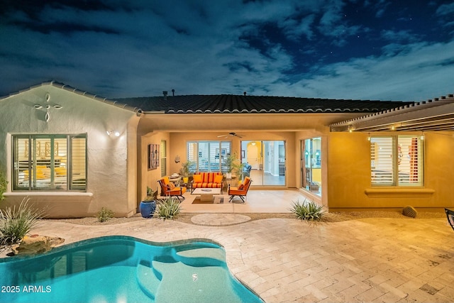 rear view of house featuring an outdoor living space, a ceiling fan, a tiled roof, an outdoor pool, and a patio area