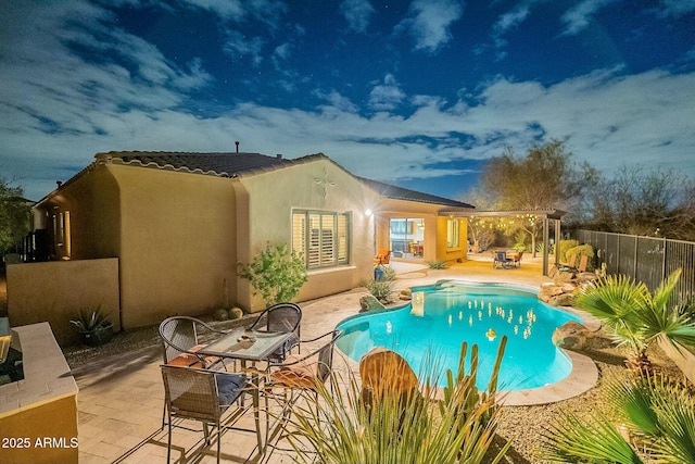 view of swimming pool featuring fence, a fenced in pool, and a patio