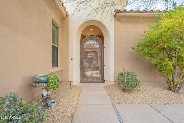 property entrance with stucco siding