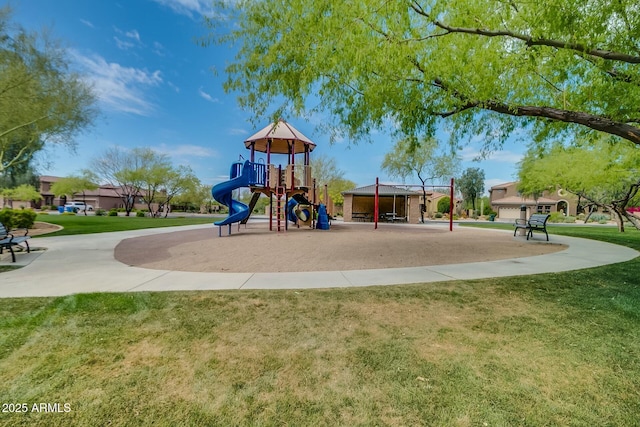 community jungle gym featuring a lawn