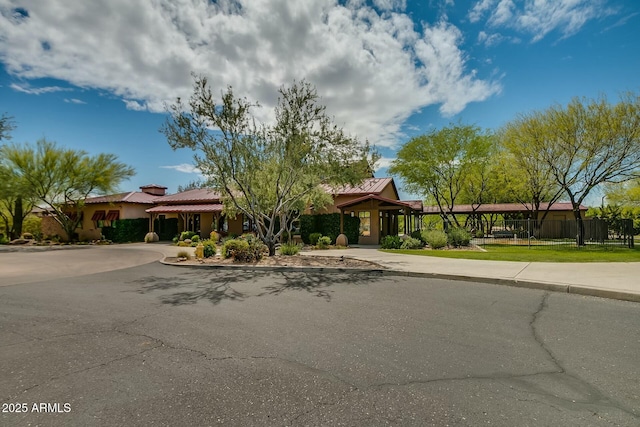 view of front of home featuring fence, a front lawn, concrete driveway, and stucco siding