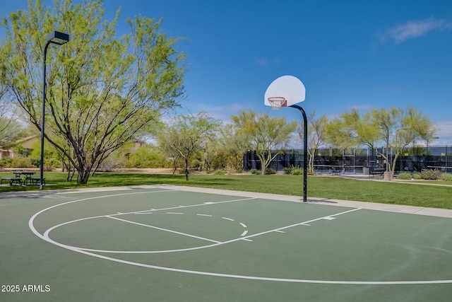 view of basketball court with community basketball court, a yard, and fence