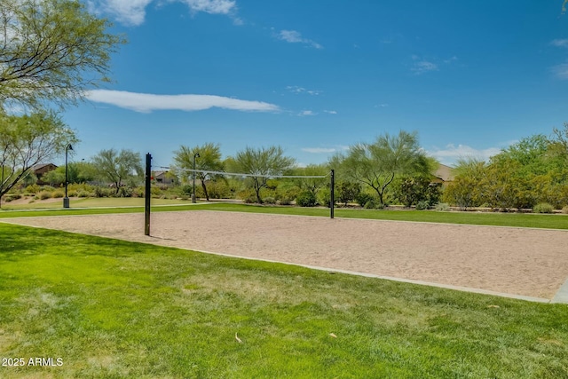 view of community with a lawn and volleyball court