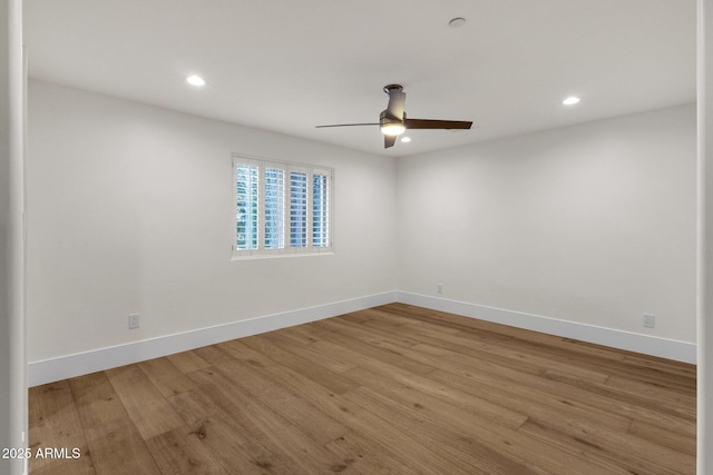 empty room with ceiling fan and light wood-type flooring