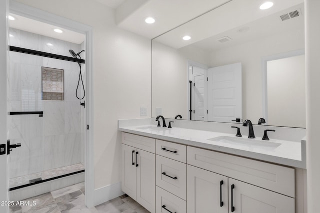 bathroom with a shower with door and vanity