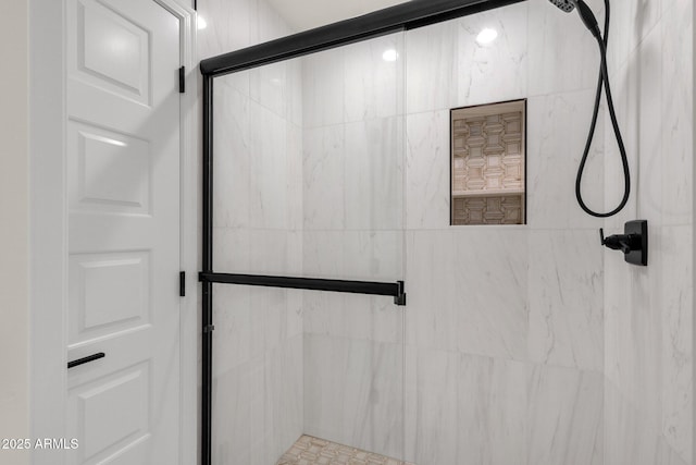 bathroom featuring a shower with shower door