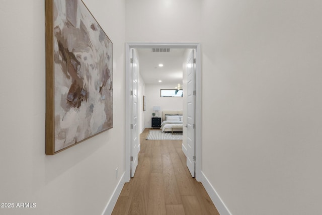 corridor with light hardwood / wood-style flooring