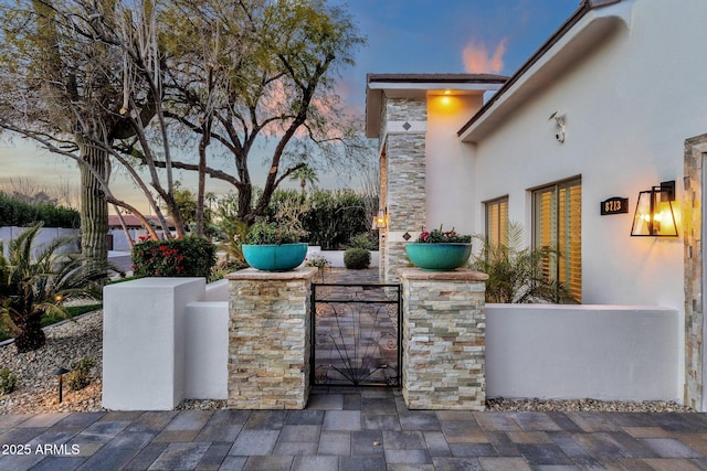 view of patio terrace at dusk