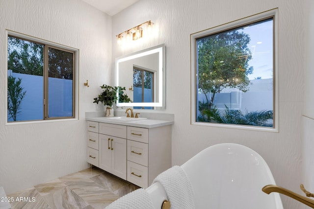 bathroom featuring vanity and a tub