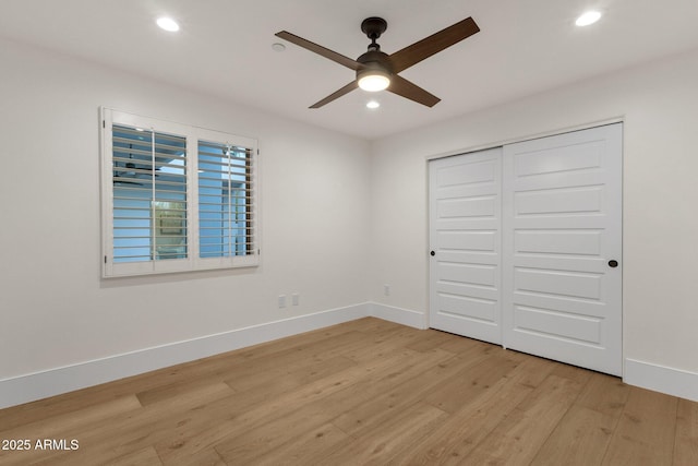 unfurnished bedroom with a closet, ceiling fan, and light hardwood / wood-style flooring