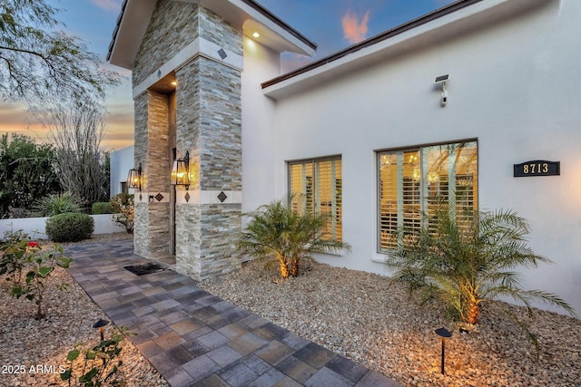 property exterior at dusk with a patio