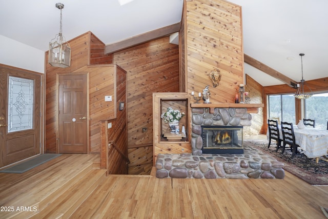 125 Partridge Ln, Prescott, AZ 86303 - foyer with a chandelier, wood finished floors, wooden walls, and a stone fireplace