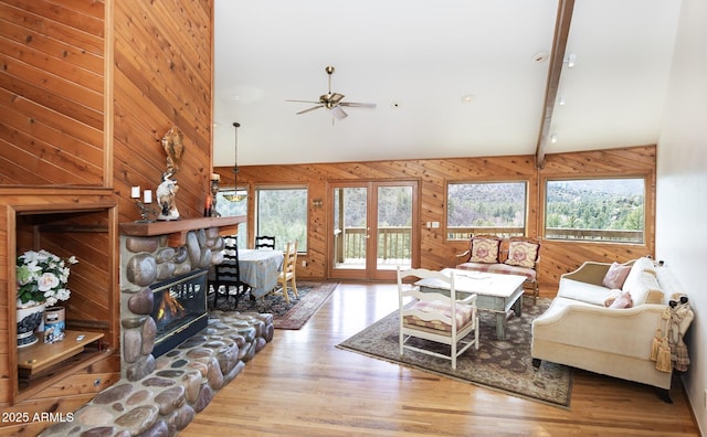 125 Partridge Ln, Prescott, AZ 86303 - living room featuring wood finished floors, wooden walls, beamed ceiling, and plenty of natural light
