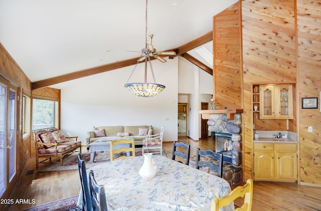 125 Partridge Ln, Prescott, AZ 86303 - dining space with light wood-style flooring, washer / clothes dryer, a chandelier, wooden walls, and beam ceiling