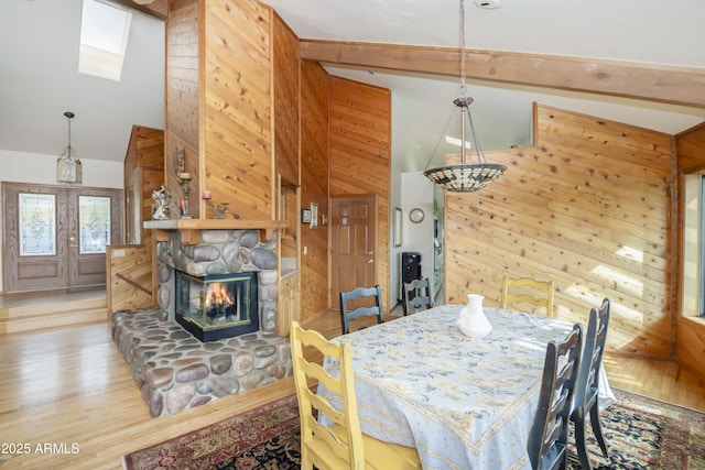 125 Partridge Ln, Prescott, AZ 86303 - dining area with a stone fireplace, wood walls, beam ceiling, high vaulted ceiling, and wood finished floors