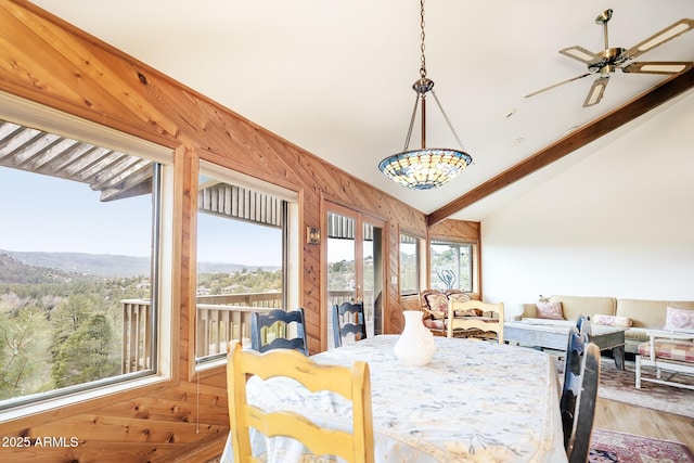 125 Partridge Ln, Prescott, AZ 86303 - dining space featuring lofted ceiling with beams, a ceiling fan, wood walls, french doors, and light wood finished floors