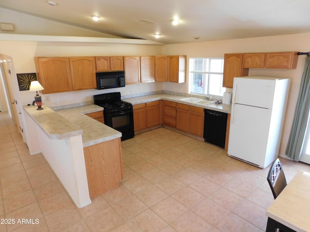 kitchen featuring light countertops, vaulted ceiling, a sink, a peninsula, and black appliances