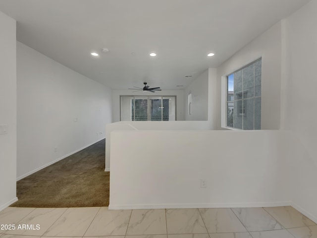 unfurnished room with recessed lighting, baseboards, and marble finish floor