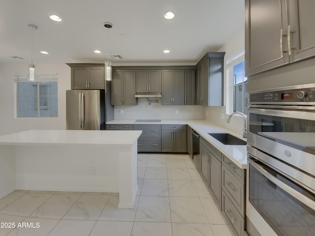 kitchen featuring a sink, gray cabinetry, stainless steel appliances, marble finish floor, and tasteful backsplash