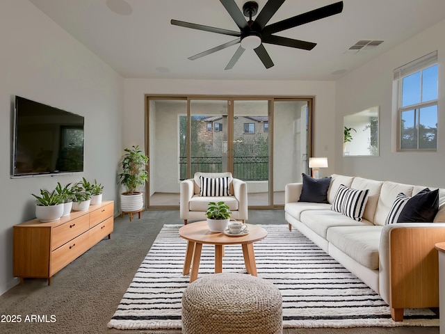 living area featuring visible vents and ceiling fan