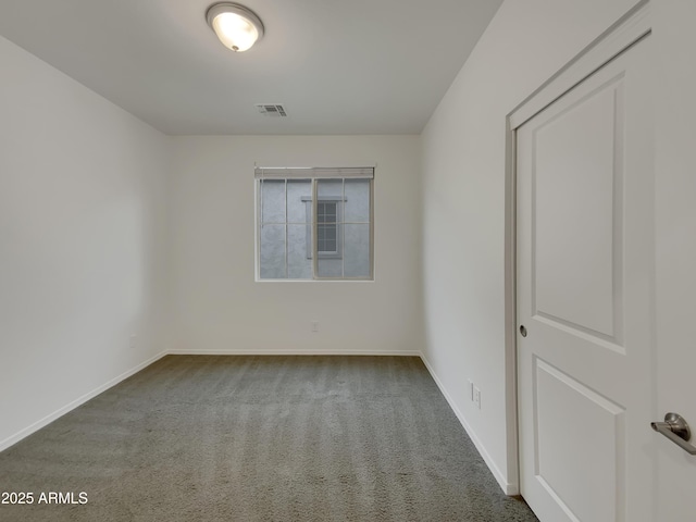 empty room with visible vents, carpet, and baseboards