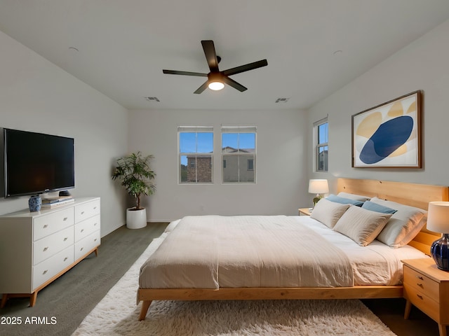 carpeted bedroom featuring visible vents and ceiling fan