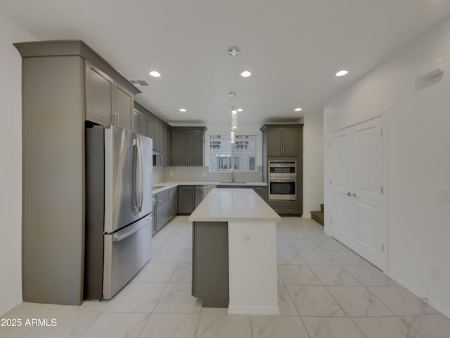 kitchen with visible vents, light countertops, appliances with stainless steel finishes, marble finish floor, and a sink