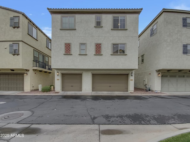 view of front of house with an attached garage and stucco siding