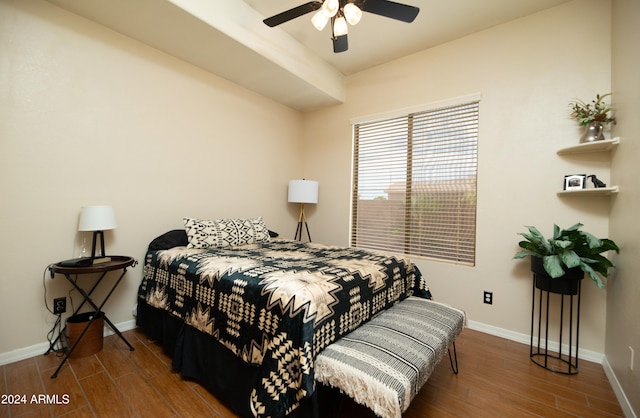 bedroom with dark hardwood / wood-style floors and ceiling fan